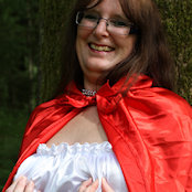 Pinching her nipples - there's a direct link from them to her clit hence the smile