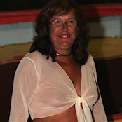 Cherry posing on a boat in short skirt and see through blouse