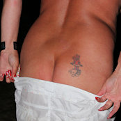 Cherry taking off her skirt from behind